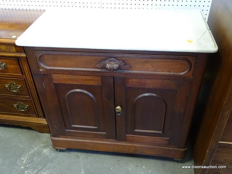 (ROW 2) VICTORIAN MARBLE TOP WASHSTAND WITH 1 DRAWER OVER 2 DOORS (DRAWER HAS A CARVED HANDLE).