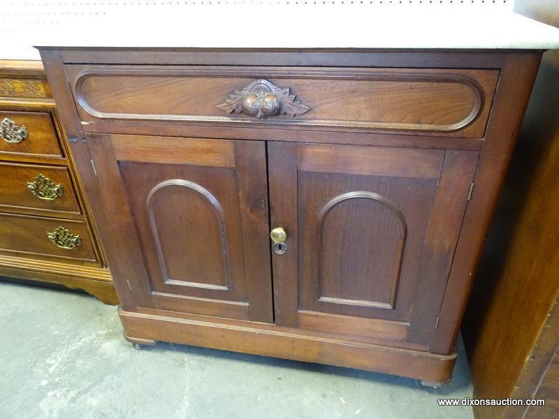 (ROW 2) VICTORIAN MARBLE TOP WASHSTAND WITH 1 DRAWER OVER 2 DOORS (DRAWER HAS A CARVED HANDLE).