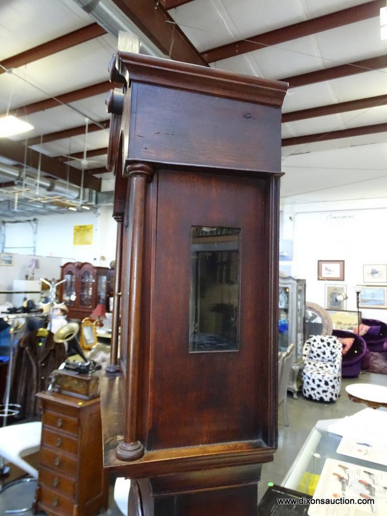 (FRONT, ROW 2) Antique Chippendale tall case clock with bracket feet. with the original weights and