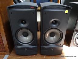 (R1) PAIR OF INFINITY SPEAKERS. MODEL RS3. IN BLACK WOOD GRAINED CASES. ONE IS MISSING THE PLASTIC