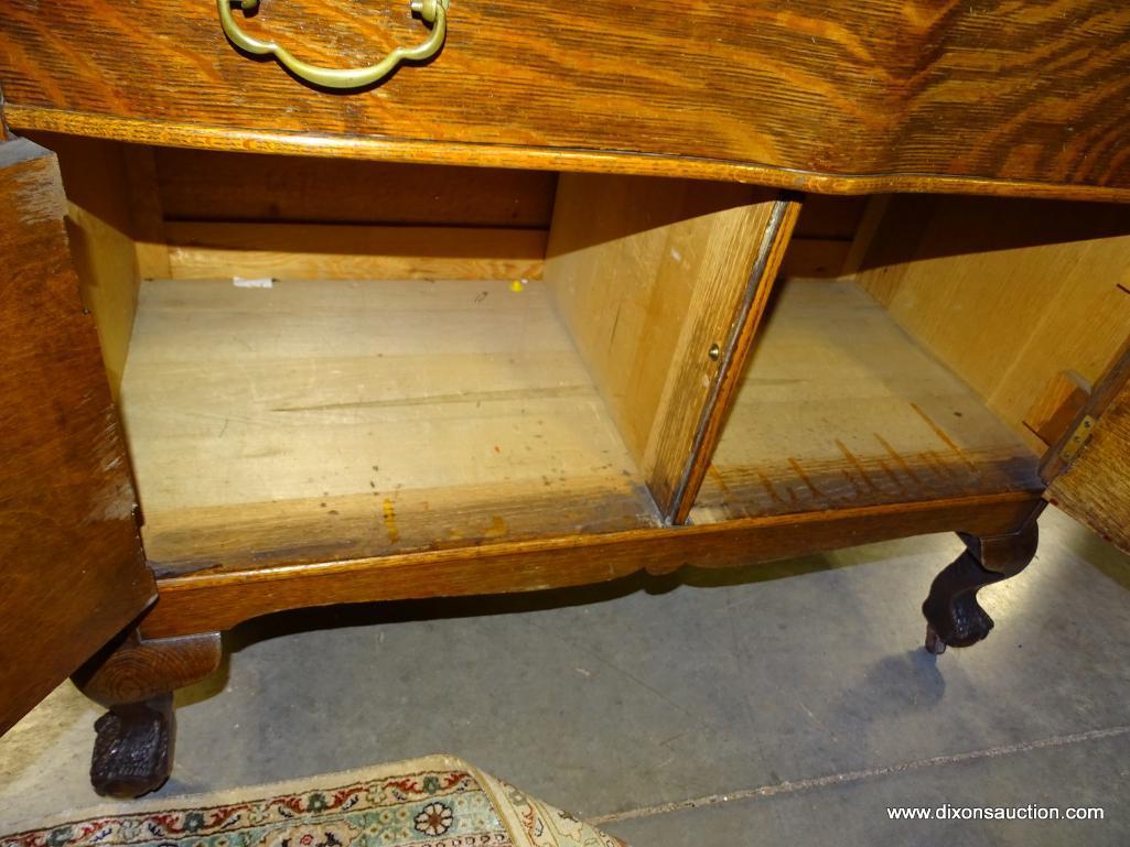 (R3) ANTIQUE BALL AND CLAW-FOOT TIGER OAK WASHSTAND WITH 1 DRAWER OVER 2 DOORS AND A TOWEL BAR.