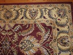 (LR) AREA RUG IN GOLD AND RUST WITH FLORAL/LEAF STYLE PATTERN: 10' 6" X 7' 11"