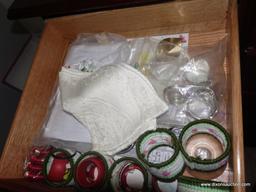 (BR2) CONTENTS OF LEFT SIDE OF SIDEBOARD: NAPKIN RINGS, DOILIES, STRING, ETC