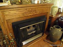 (LR) LARGE WOODEN ELECTRIC FIREPLACE; LIGHT OAK CABINET WITH MOLDING AT TOP AND BOTTOM WITH CARVED