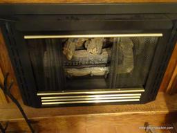 (LR) LARGE WOODEN ELECTRIC FIREPLACE; LIGHT OAK CABINET WITH MOLDING AT TOP AND BOTTOM WITH CARVED