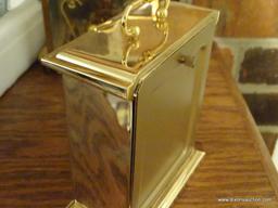 (LR) HOWARD MILLER BRASS MANTEL CLOCK; VERY HEAVY, RECTANGULAR WITH SMALL HANDLE AT TOP, MODEL