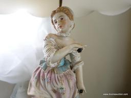 (BED) PORCELAIN VICTORIAN STATUE LAMP WITH LAMPSHADE; YOUNG MAIDEN IN PASTEL SHADES STANDING ON A