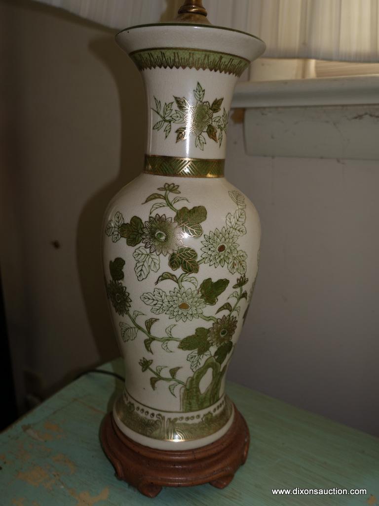 (BED) ORIENTAL STYLE LAMP; IVORY COLORED WITH MUTED GREEN AND GOLD PAINTED FLORAL DESIGN. SITS ATOP
