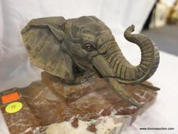 (DIS)ELEPHANT HEAD ON MARBLE PEDESTAL