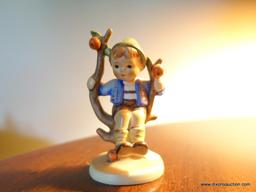 (LR) HUMMEL FIGURINE OF BOY SITTING IN THE APPLE TREE- MARKED WITH BEE- 4"H