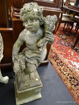 CONCRETE CHERUB STATUE; STANDING CHILD CHERUB CARRYING BUNDLES OF WHEAT OVER A SHOULDER AND IN HAND