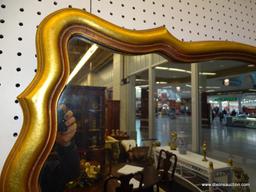 GOLD TRIMMED WALL MIRROR; MOLDED EDGE IN A SCALLOPED RECTANGULAR PATTERN AND SHAPE. DEEP RICH GOLDEN