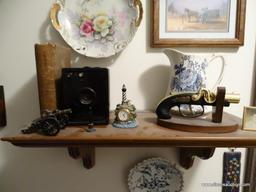 (UHAL) CONTENTS OF WALL NEAR STAIRWAY: WOODEN SHELF, VINTAGE ANSCO CAMERA, VINTAGE PLATE (DATED ON