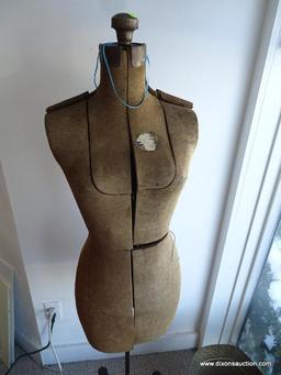 VINTAGE DRESS FORM; UPHOLSTERED GREYISH-TAN FABRIC COVERED BODY WITH 10 ADJUSTABLE PANELS, AN IRON
