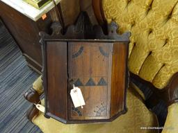 WOODEN VINTAGE HANGING CORNER CABINET; WITH KEY IN KEYHOLE ON FRONT. CARVED BACKSPLASH DESIGN FLOWS