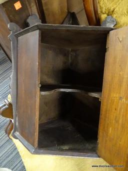 WOODEN VINTAGE HANGING CORNER CABINET; WITH KEY IN KEYHOLE ON FRONT. CARVED BACKSPLASH DESIGN FLOWS