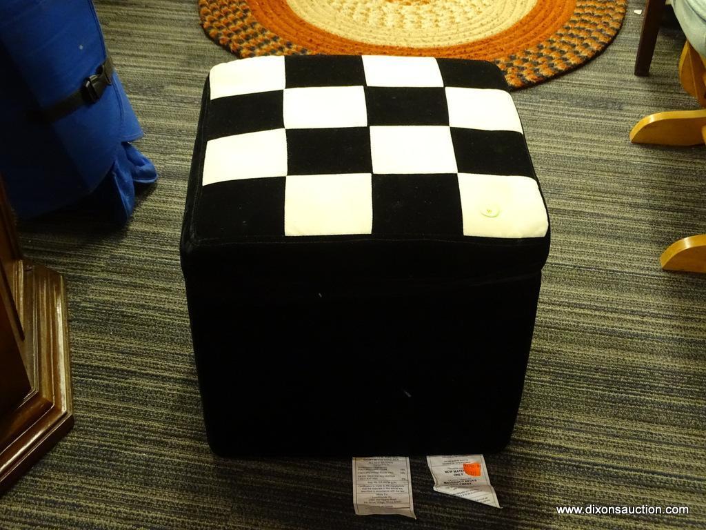 BLACK VELVET CUBE OTTOMAN WITH CHECKERBOARD PATTERNED TOP; HINGED LID ALSO HAS A ZIPPING CLOSURE.