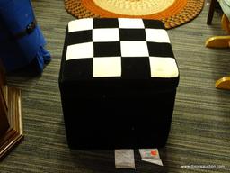 BLACK VELVET CUBE OTTOMAN WITH CHECKERBOARD PATTERNED TOP; HINGED LID ALSO HAS A ZIPPING CLOSURE.