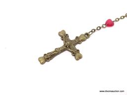 VINTAGE ROSARY WITH RED PLASTIC HEART SHAPED BEADS; ON A BRONZE COLORED CHAIN WITH OVAL SHAPED MEDAL