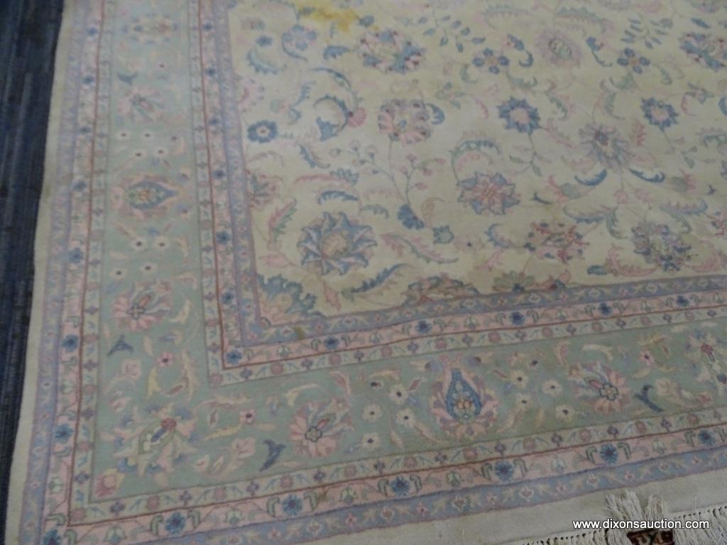 HAND KNOTTED ORIENTAL AREA RUG WITH SOME STAINING. IS IN PASTEL GREENS, YELLOWS, AND PINKS. MEASURES