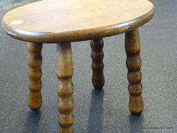 (WIN) OVAL WOODEN FOOTSTOOL WITH SPOOLED LEGS; MEASURES 12.5 IN X 9.5 IN X 9.5 IN TALL. HAS PRINTED