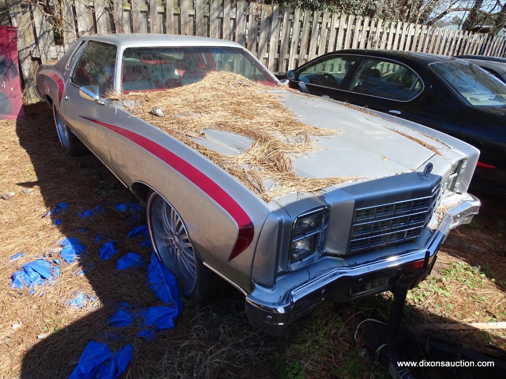 1977 SILVER MONTE CARLO; VIN 1H57U7B587408. SILVER WITH RED STRIPES. THIS CAR WAS ABANDONED AT A