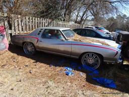 1977 SILVER MONTE CARLO; VIN 1H57U7B587408. SILVER WITH RED STRIPES. THIS CAR WAS ABANDONED AT A