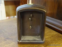 (R1) POTTERY BARN ALARM CLOCK; BROWN METAL CASE WITH BRASS COLORED FACE AMD A SLIGHTLY ROUNDED TOP.