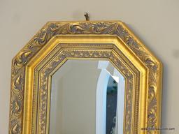 (DR) GOLD COLORED OCTAGONAL WALL MIRROR; BEVELED GLASS SURROUNDED BY A MOLDED SHADOW BOX-STYLE