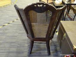 ANTIQUE TRIPLE PANEL CANE WINGBACK CHAIR; WOODEN CARVED FRAME WITH PATTERNED CREST, 3 PANELED BACK