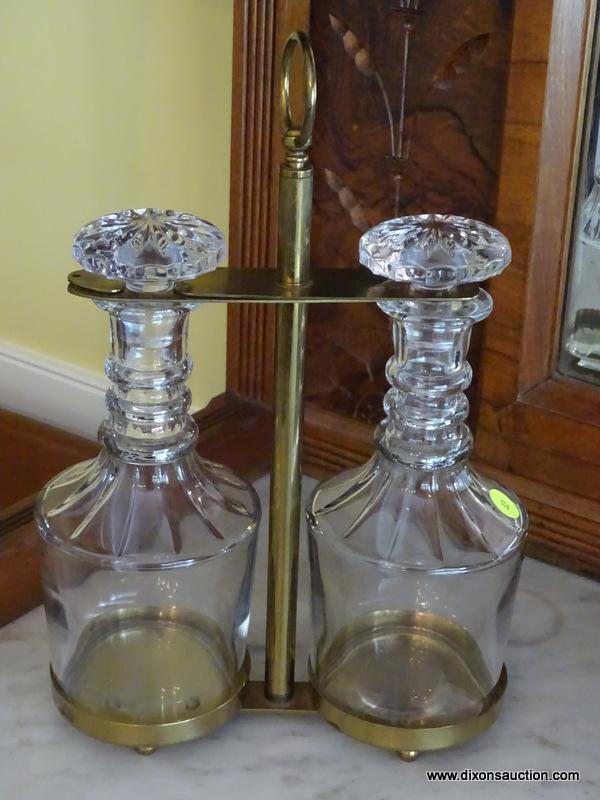 (DR) PAIR OF MATCHING CUT GLASS DECANTERS WITH STOPPERS IN BRASS HOLDER WITH LOOP HANDLE; EACH