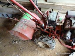 (OUT) BRIGGS & STRATTON TILLER; HAS 8 HP CAPABILITY AND AN I/C SERIES ENGINE. IS RED IN COLOR. IN