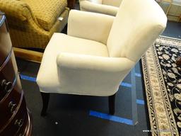 UPHOLSTERED ARM CHAIR; 1 OF A PAIR OF CREAM UPHOLSTERED ARM CHAIRS WITH MAHOGANY LEGS. VERY CLEAN