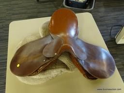 LEATHER 17 IN HORSE SADDLE; COMES WITH A FLEECE SADDLE PAD. IS CARAMEL BROWN IN COLOR.