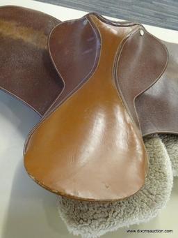 LEATHER 17 IN HORSE SADDLE; COMES WITH A FLEECE SADDLE PAD. IS CARAMEL BROWN IN COLOR.