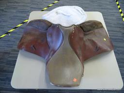 REGENT SADDLER 17 IN LEATHER HORSE SADDLE; IS BROWN IN COLOR AND INCLUDES A SADDLE PAD.