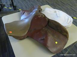 REGENT SADDLER 17 IN LEATHER HORSE SADDLE; IS BROWN IN COLOR AND INCLUDES A SADDLE PAD.