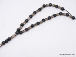 LOT OF ASSORTED RELIGIOUS JEWELRY; LOT INCLUDES A BLACK BEADED ROSARY, AND A SILVER TONE CHAIN WITH