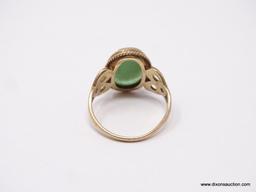 LADIES 10K GOLD RING; GREEN CAMEO CENTER ON A 10K GOLD BAND WITH SCROLLING HEARTS ON THE SIDES. SIZE