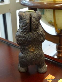 COIN BANK; VINTAGE CAST IRON BANK IN THE FORM OF A BLACK BEAR. MEASURES 6.5 IN TALL.