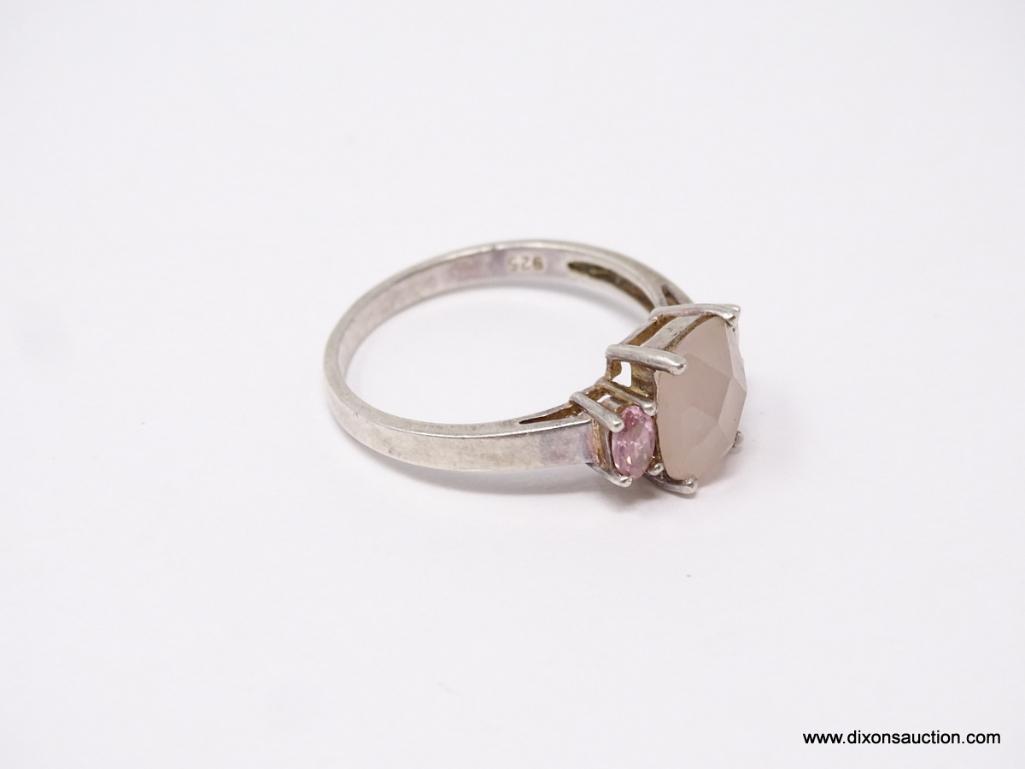 LADIES .925 STERLING SILVER RING; LARGE PINK CENTER GEMSTONE WITH PINK STONE ON EACH SIDE. SIZE 11.