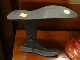 CAST IRON COBBLER SHOE STAND; MARKED "UNBREAKABLE HANDY", BLACK AGED CAST IRON. MEASURES 8 IN TALL.