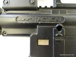 (FRONT) JT TACTICAL PAINTBALL GUN; THIS TAN AND BLACK PAINTBALL GUN INCLUDES A RAISED SIGHT RAIL,