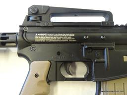 (FRONT) JT TACTICAL PAINTBALL GUN; THIS TAN AND BLACK PAINTBALL GUN INCLUDES A RAISED SIGHT RAIL,