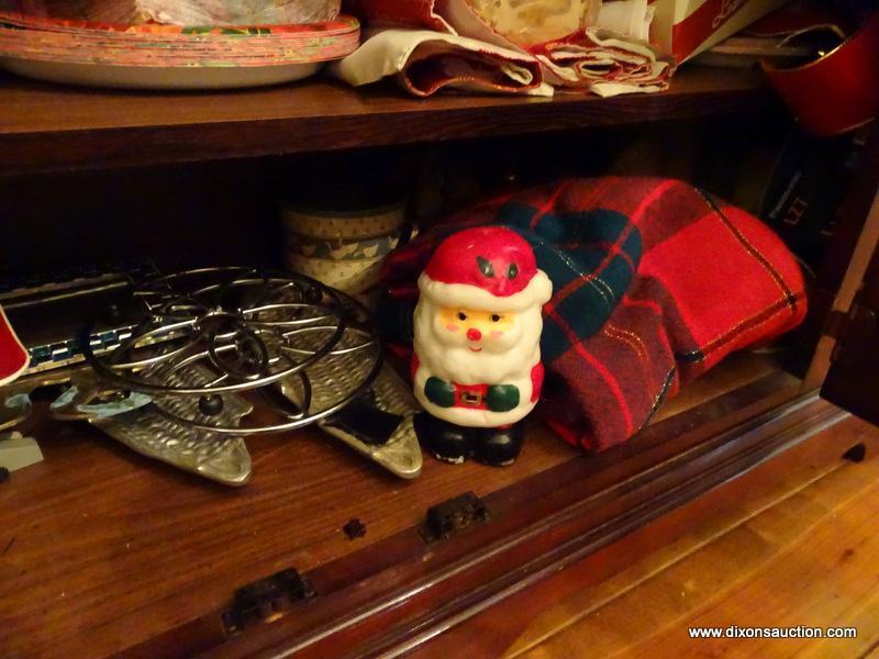 (DR) CONTENTS OF LOWER PORTION OF CHINA CABINET; CHRISTMAS TOWELS, CANDLES, CHRISTMAS PLACEMATS,