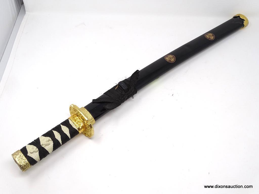 SHORT JAPANESE KATANA; SHORT SAMURAI SWORD WITH A BLACK METAL SHEATH AND GOLD TONED METAL CAPS.