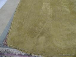 HAND KNOTTED AREA RUG; TAN HAND KNOTTED RUG WITH FRINGE DETAILING ALONG EACH SIDE. MEASURES APPROX.