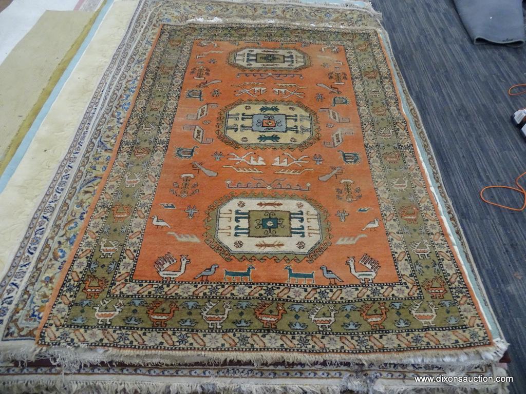 HAND KNOTTED AREA RUG; RED-ORANGE RUG WITH CREAM AND TAN BORDER WITH ANIMALS ON IT. HAS FRINGE