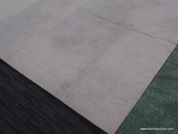 AREA RUG; OFF-WHITE MACHINE MADE AREA RUG WITH SWIRLING DESIGN. 100 % OLEFIN PILE. MEASURES