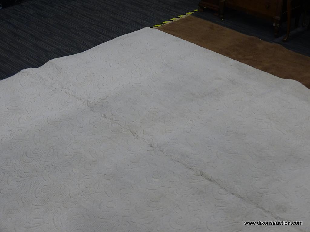 AREA RUG; OFF-WHITE MACHINE MADE AREA RUG WITH SWIRLING DESIGN. 100 % OLEFIN PILE. MEASURES